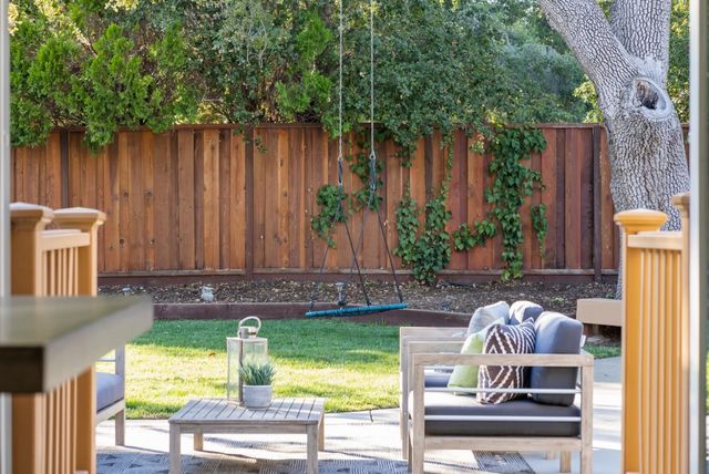 a view of backyard with swimming pool and outdoor seating