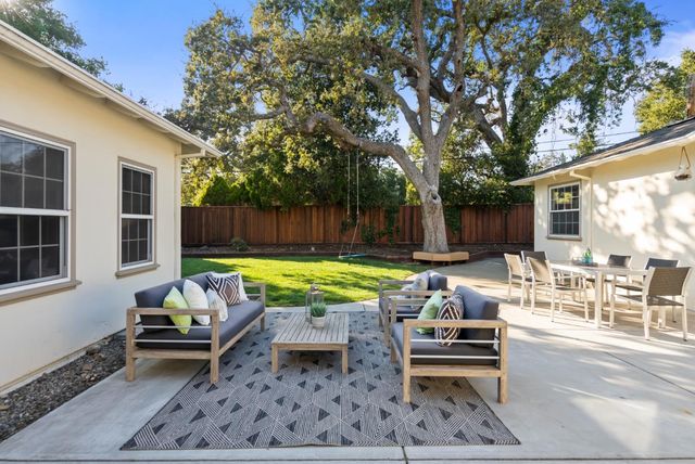 a swimming pool with outdoor seating and yard