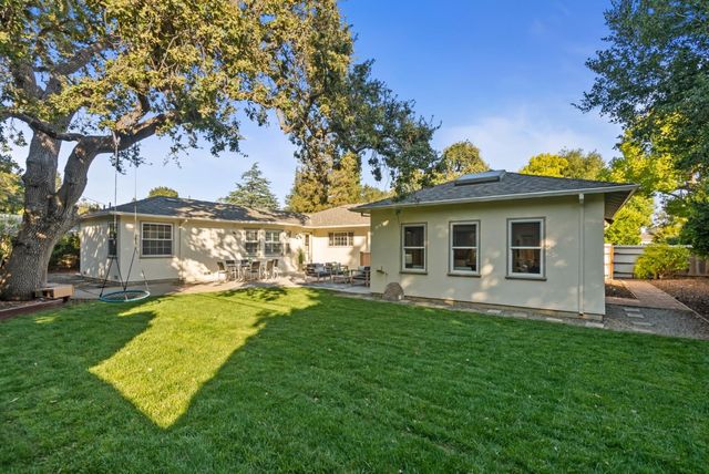 a front view of a house with a garden and patio