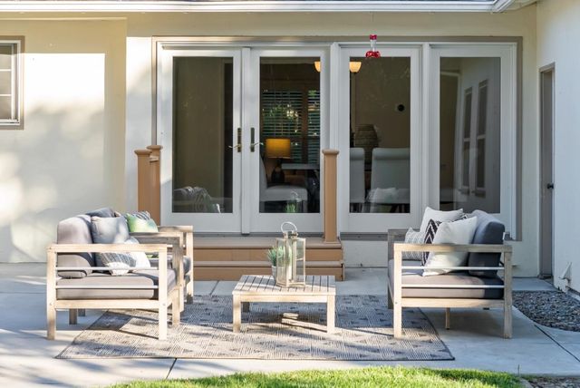 a view of a chairs and table in the backyard