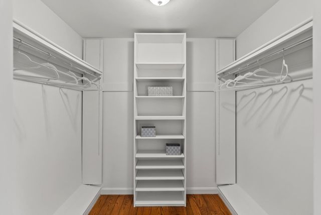 a bathroom with a granite countertop sink mirror and a bathtub
