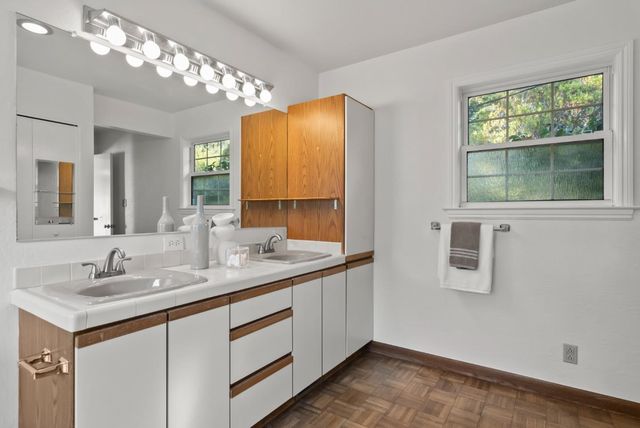 a bath tub sitting in a bathroom next to a window