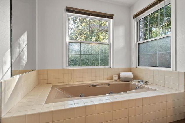 a spacious bedroom with a bed and a couch