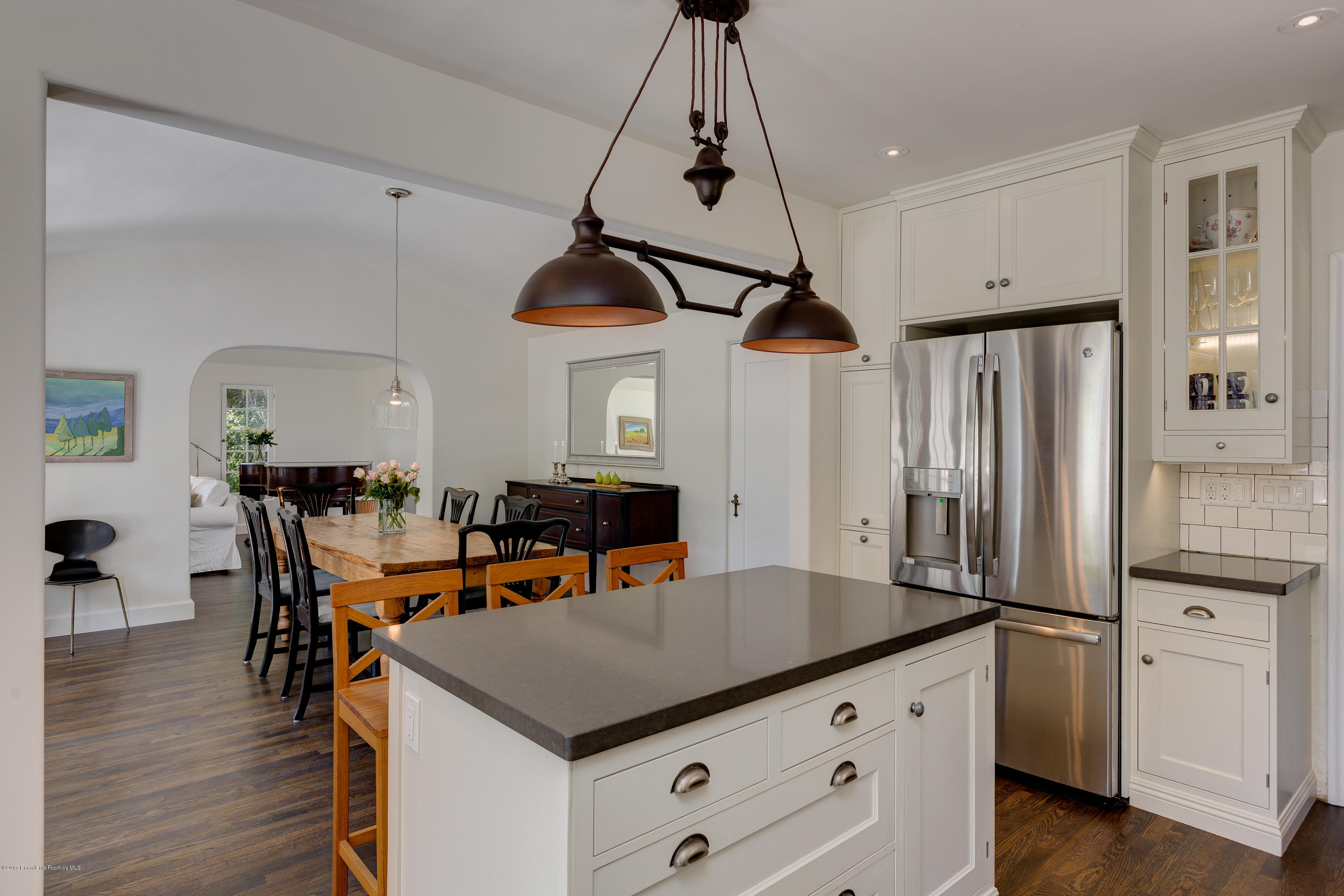 2529 Marengo Avenue Altadena, CA 91001 - Photo 15 of 42 a kitchen with stainless steel appliances kitchen island a refrigerator a stove a dining table and chairs with wooden floor