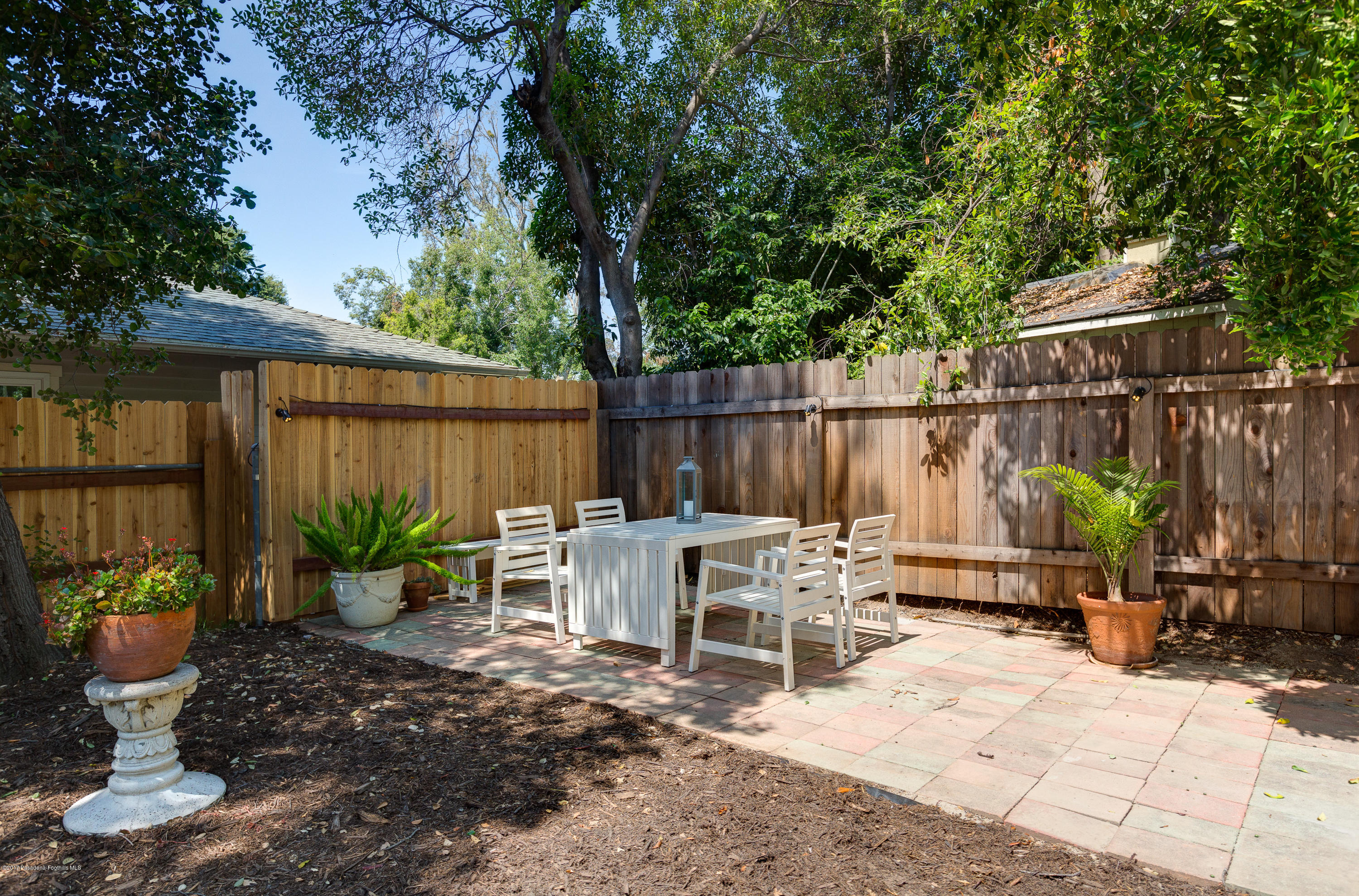 2529 Marengo Avenue Altadena, CA 91001 - Photo 37 of 42 a view of a patio with table and chairs potted plants and wooden fence