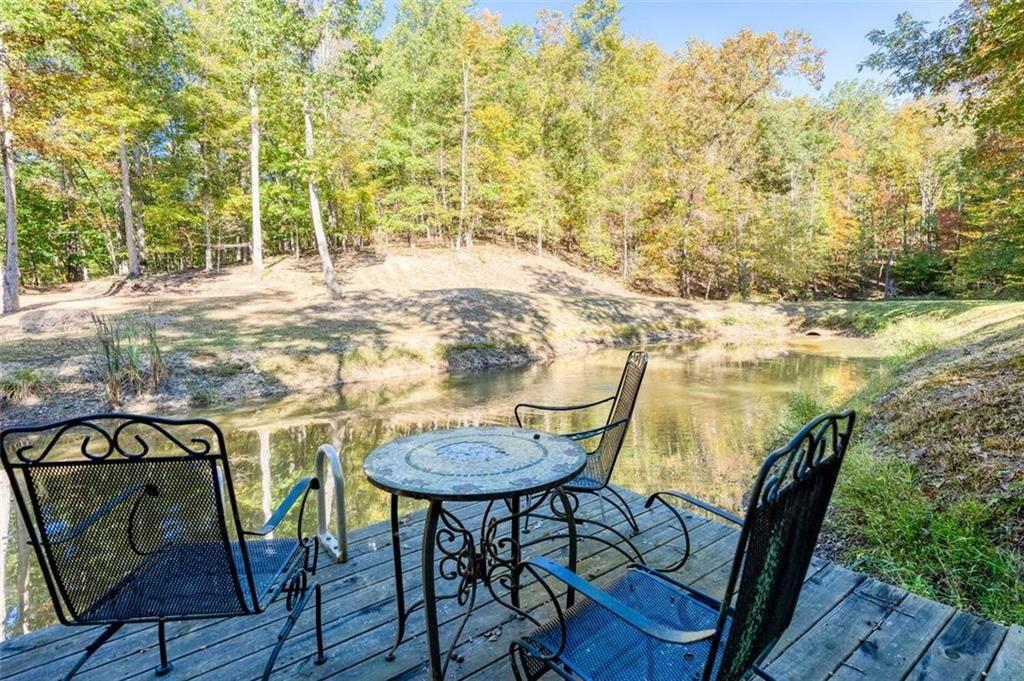 0 Vinson Mountain Road Rockmart, GA 30153 - Photo 44 of 48 a view of a chairs and table on the wooden deck