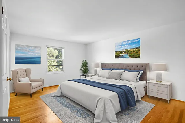 a bedroom with a bed a couch and a window