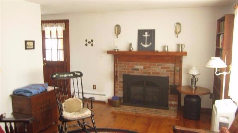 65 Upper Marsh Road Wellfleet, MA 02667 - Photo 15 of 24 a living room with furniture and a fireplace