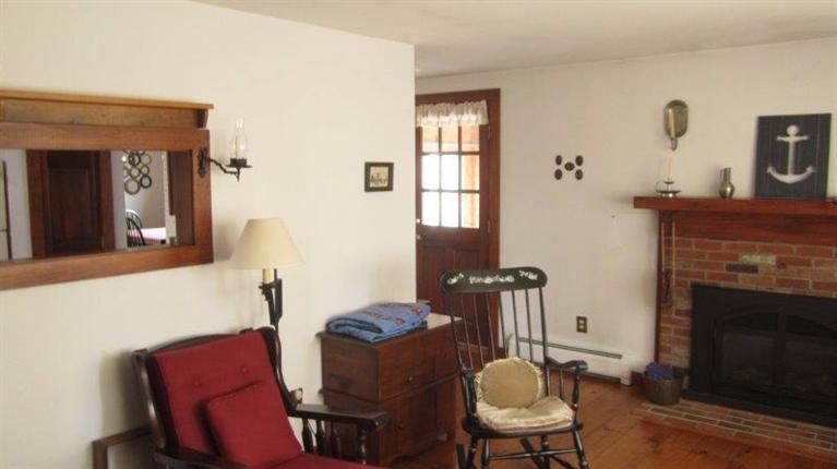 65 Upper Marsh Road Wellfleet, MA 02667 - Photo 16 of 24 a living room with furniture and a fireplace