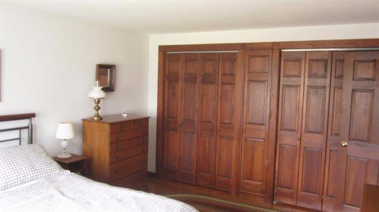 65 Upper Marsh Road Wellfleet, MA 02667 - Photo 18 of 24 a bedroom with a bed and cabinets