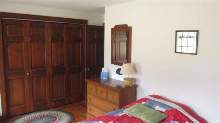 65 Upper Marsh Road Wellfleet, MA 02667 - Photo 21 of 24 a bedroom with a bed and a dresser