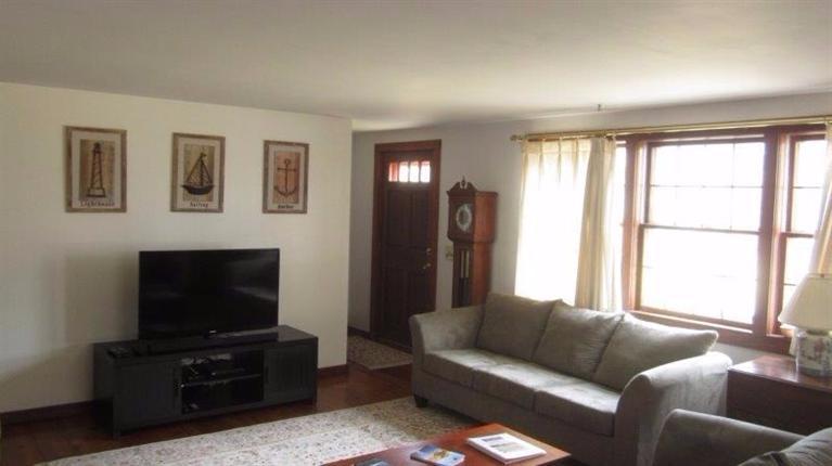 65 Upper Marsh Road Wellfleet, MA 02667 - Photo 9 of 24 a living room with furniture and a flat screen tv