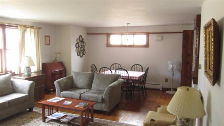 65 Upper Marsh Road Wellfleet, MA 02667 - Photo 10 of 24 a living room with furniture a window and a flat screen tv