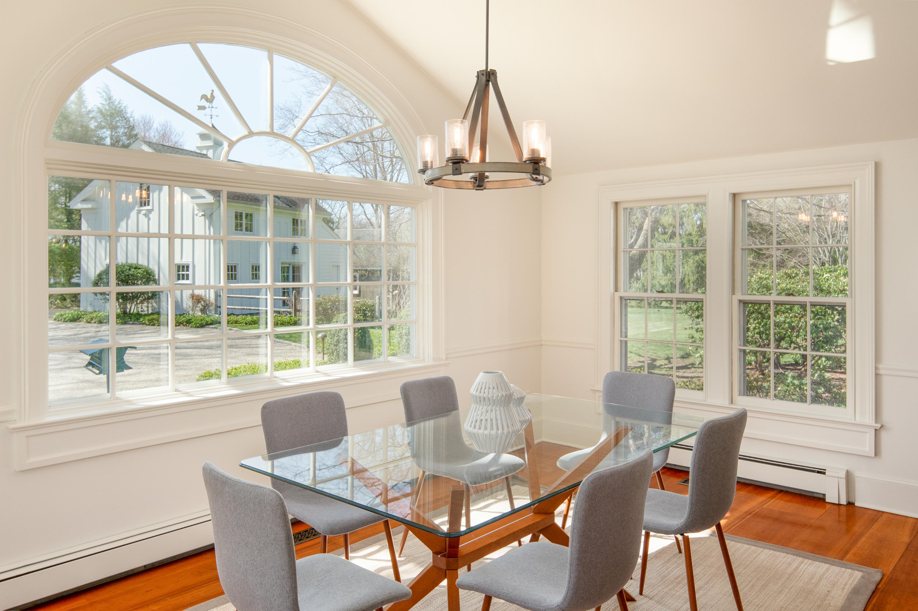 469 Brookside Road New Canaan, CT 06840 - Photo 11 of 39 a view of a dining room with furniture large windows and wooden floor