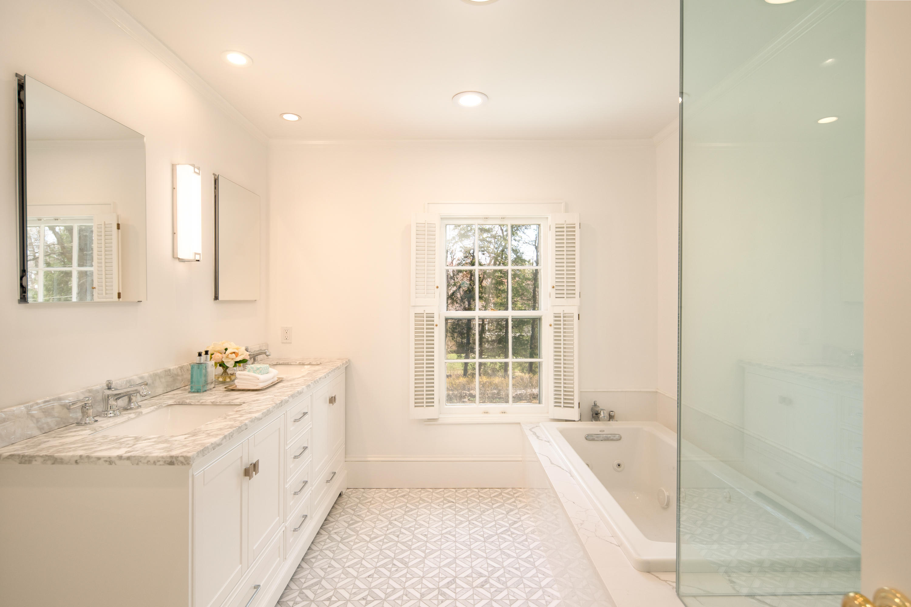 469 Brookside Road New Canaan, CT 06840 - Photo 22 of 39 a spacious bathroom with a tub sink and mirror