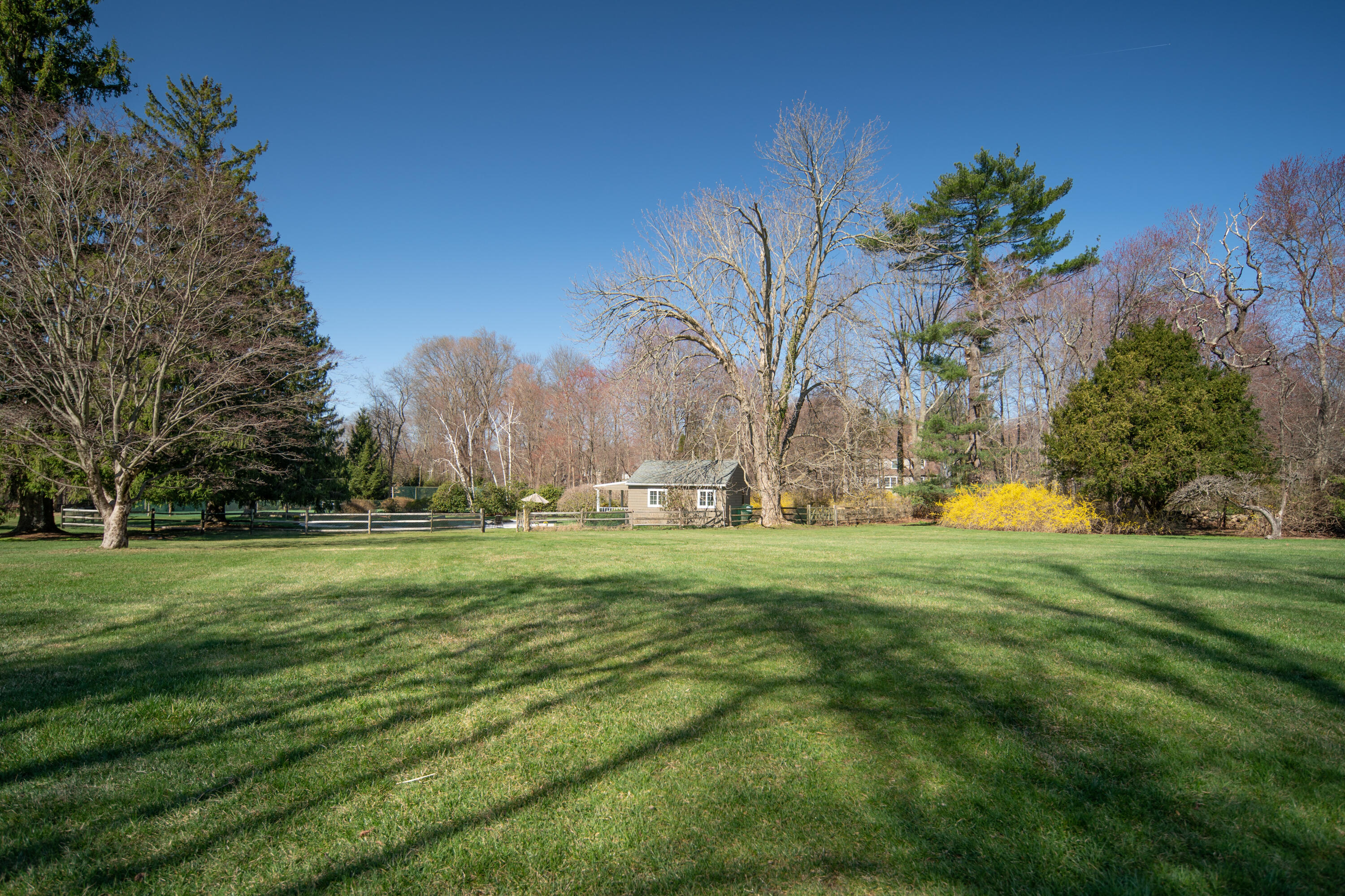 469 Brookside Road New Canaan, CT 06840 - Photo 30 of 39 a backyard of a house with table and chairs