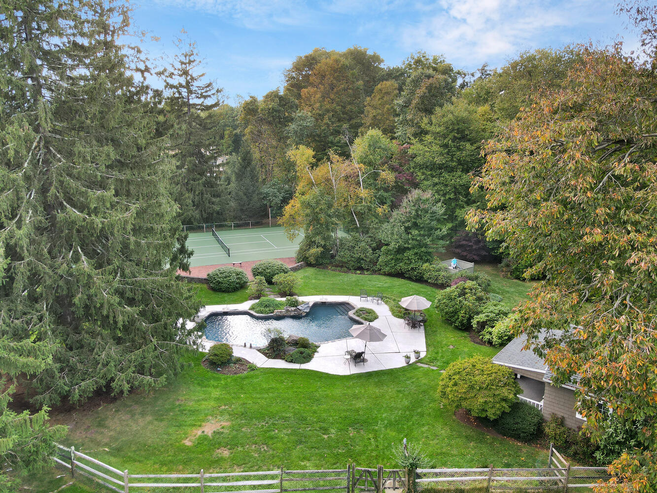 469 Brookside Road New Canaan, CT 06840 - Photo 31 of 39 a backyard of a house with a yard and outdoor seating