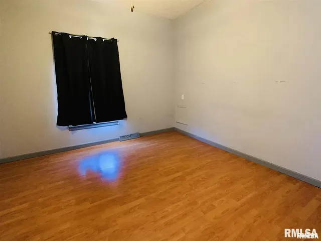 an empty room with a wooden floor