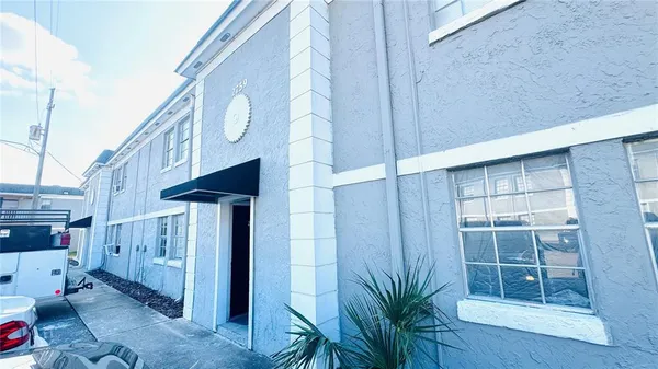 a view of a house with a potted plant and a window