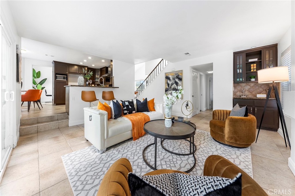 39 Viewpoint Circle Pomona, CA 91766 - Photo 18 of 49 a living room with furniture and a dining table with wooden floor