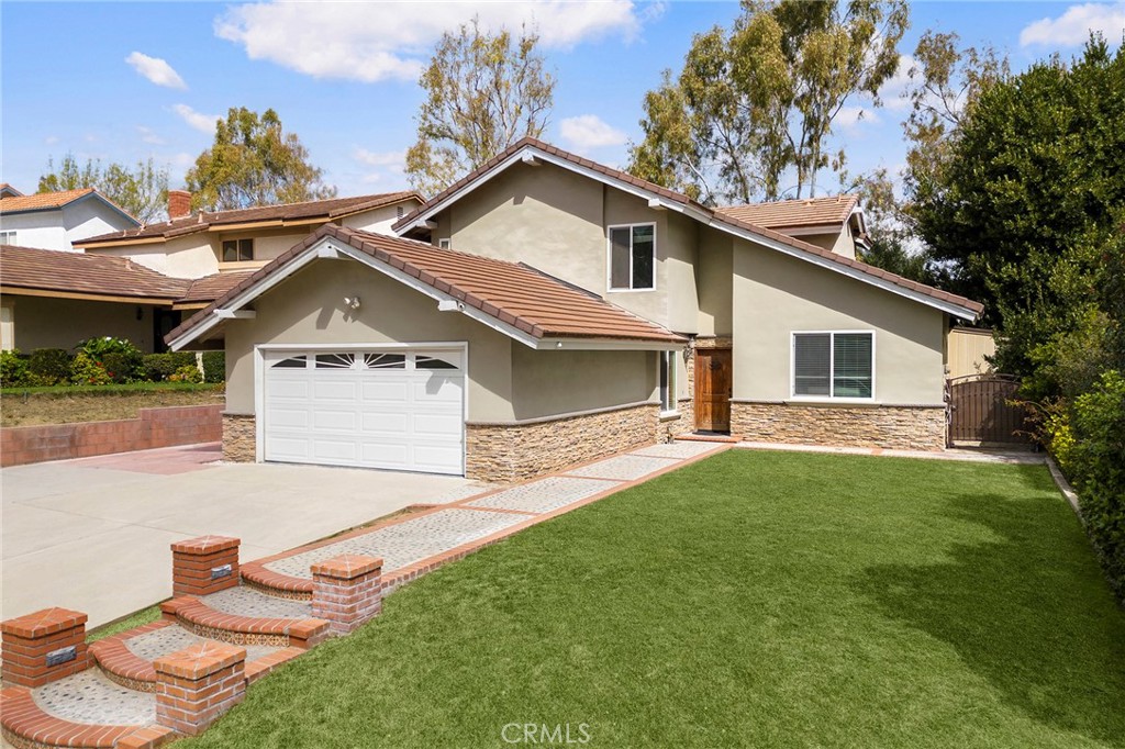 39 Viewpoint Circle Pomona, CA 91766 - Photo 2 of 49 a front view of a house with a yard
