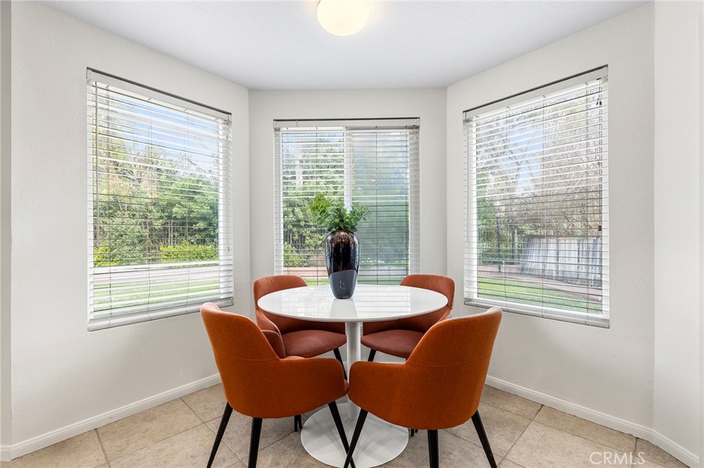 39 Viewpoint Circle Pomona, CA 91766 - Photo 21 of 49 a dining room with furniture a rug and wooden floor