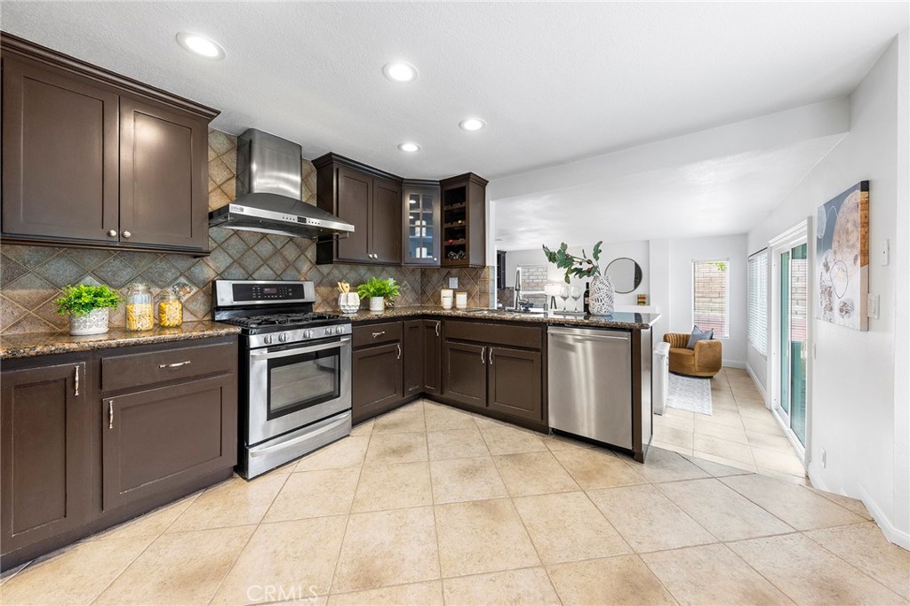 39 Viewpoint Circle Pomona, CA 91766 - Photo 23 of 49 a kitchen with stainless steel appliances granite countertop a stove sink and cabinets