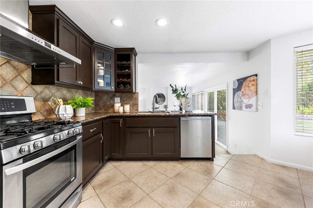 39 Viewpoint Circle Pomona, CA 91766 - Photo 24 of 49 a kitchen with stainless steel appliances granite countertop a stove a sink and a microwave