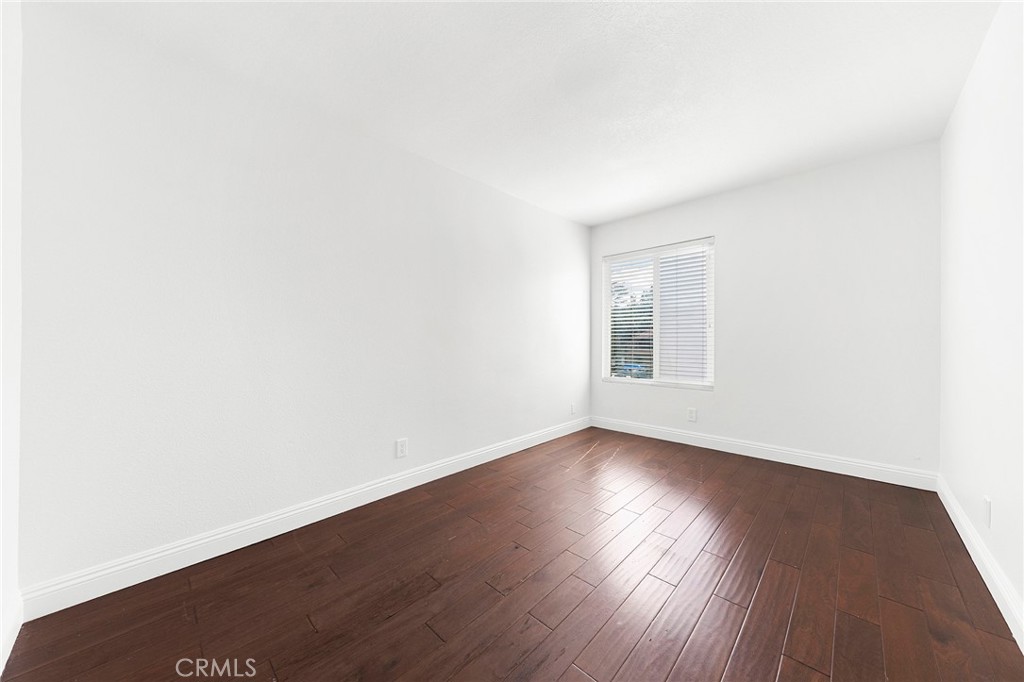 39 Viewpoint Circle Pomona, CA 91766 - Photo 38 of 49 an empty room with wooden floor and windows