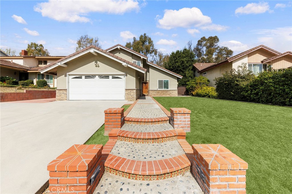 39 Viewpoint Circle Pomona, CA 91766 - Photo 5 of 49 a front view of a house with a yard and garage