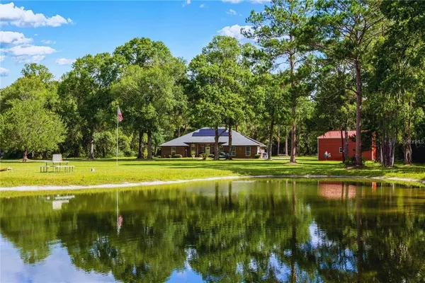 a view of pool with a yard