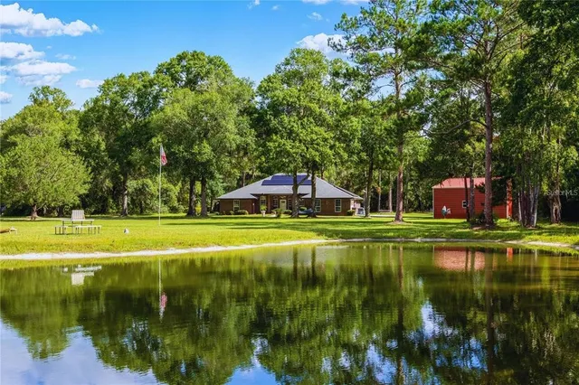 a view of pool with a yard