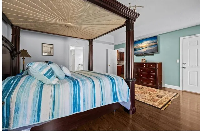 a bedroom with a bed a dresser and book shelf