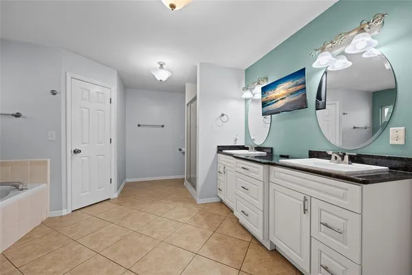 a spacious bathroom with a double vanity sink and a mirror