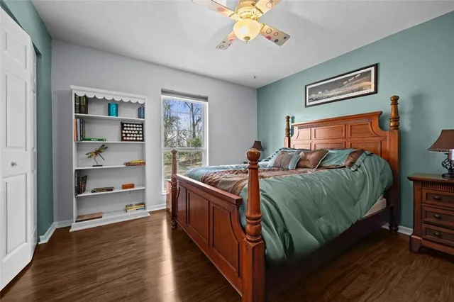 a bed sitting in a bedroom next to a window