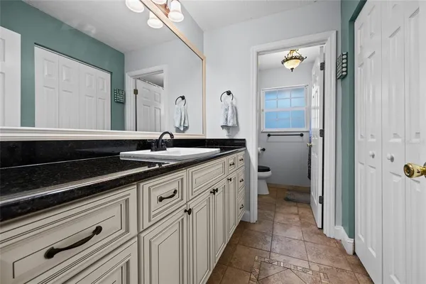 a spacious bathroom with a sink and a mirror