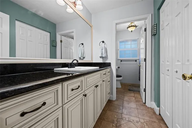 a spacious bathroom with a sink and a mirror
