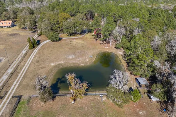 an aerial view of a house with a yard