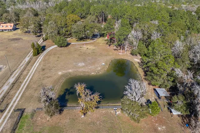 an aerial view of a house with a yard
