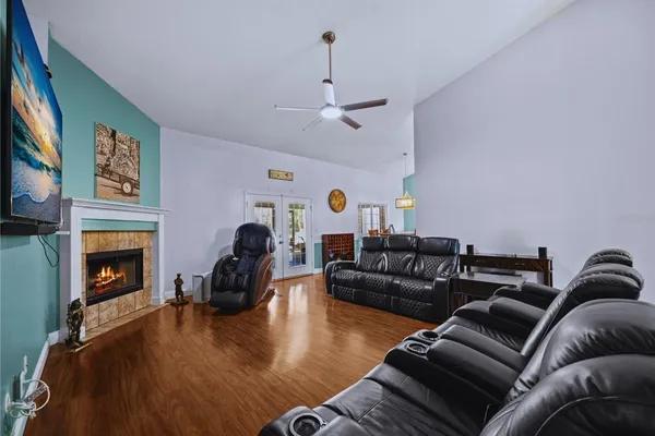 a living room with furniture a fireplace and a flat screen tv
