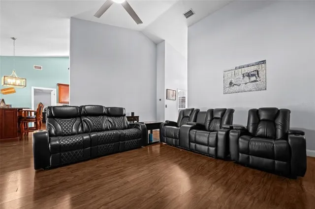 a living room with furniture and a wooden floor