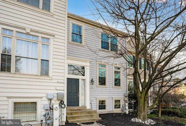 a front view of a house with a trees