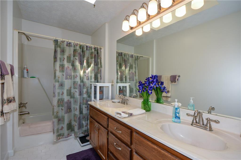 130 Hawn Road Fayetteville, GA 30215 - Photo 27 of 67 a bathroom with a double vanity sink and a mirror