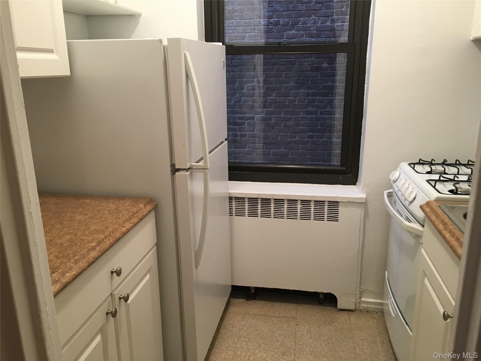 23 Schenck Avenue, Unit 1BD Great Neck, NY 11021 - Photo 7 of 14 a bathroom with a granite countertop sink and a washing machine