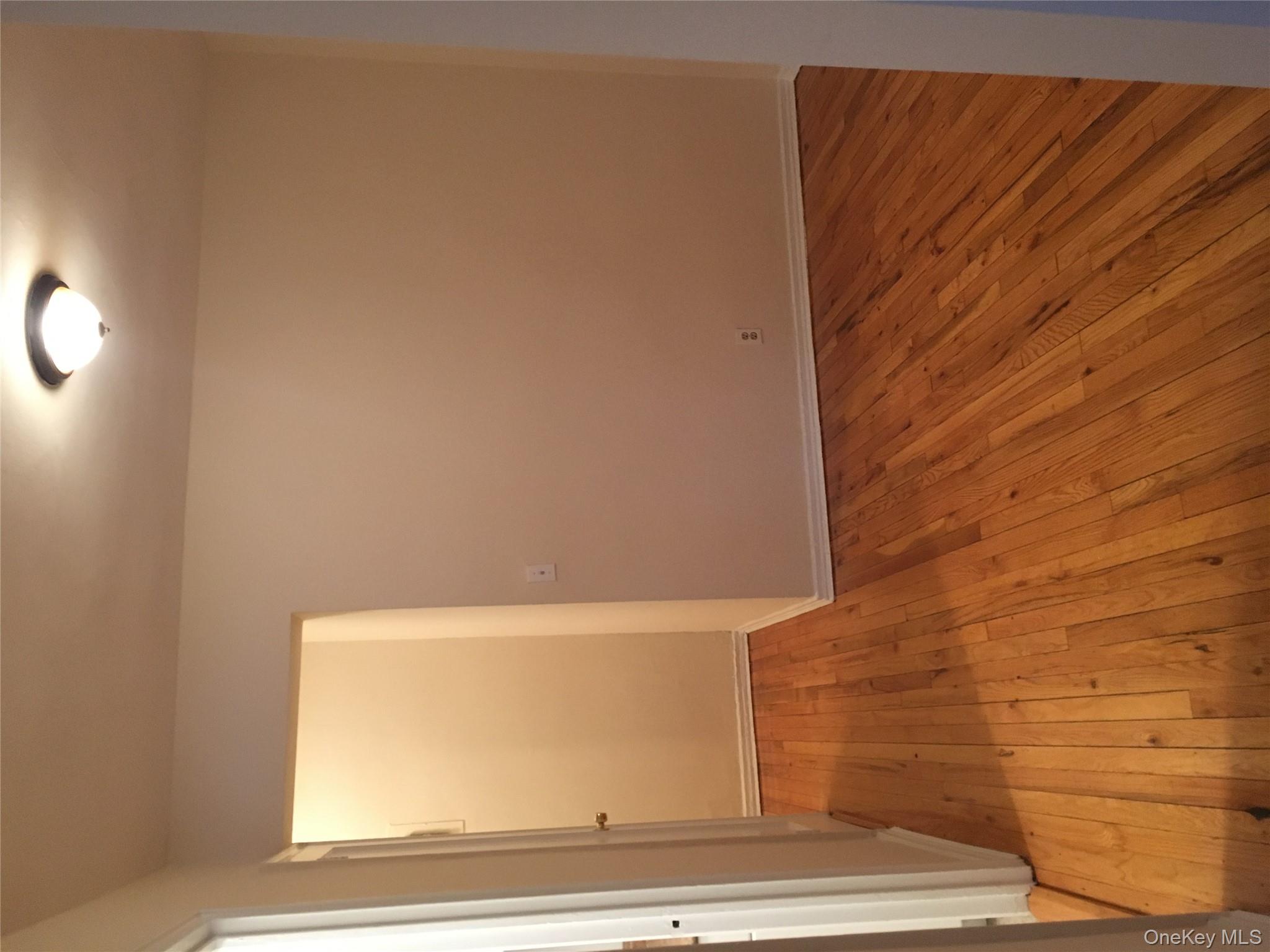 23 Schenck Avenue, Unit 1BD Great Neck, NY 11021 - Photo 8 of 14 an empty room with wooden floor and windows