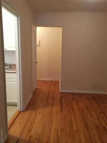 a view of a room with wooden floor
