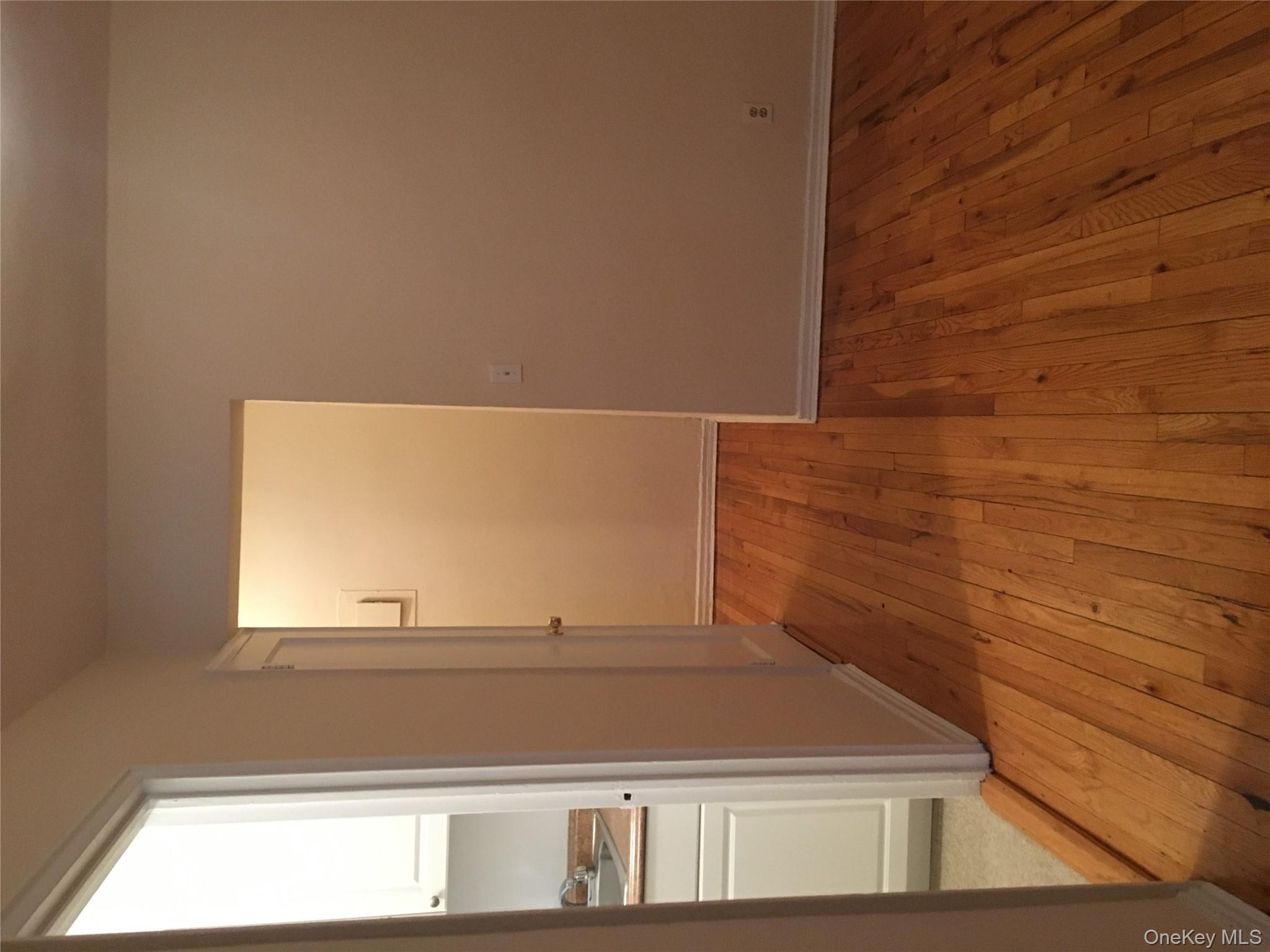 23 Schenck Avenue, Unit 1BD Great Neck, NY 11021 - Photo 9 of 14 a view of a room with wooden floor