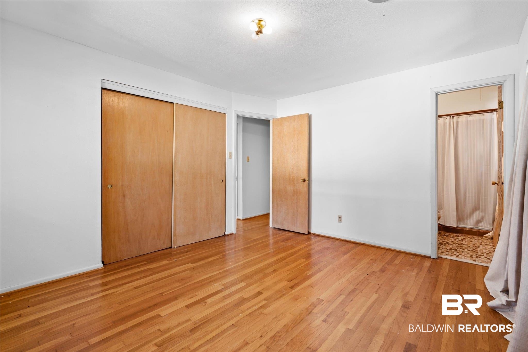 602 Markham Drive Mobile, AL 36609 - Photo 9 of 20 Unfurnished bedroom featuring light hardwood / wood-style floors, a closet, and ensuite bathroom