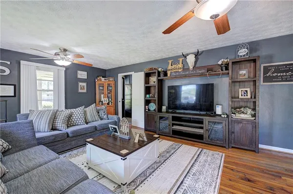 a living room with fireplace furniture and a flat screen tv