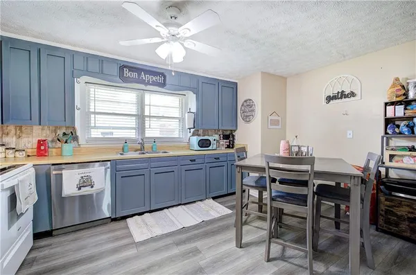a kitchen with stainless steel appliances a refrigerator and a stove top oven